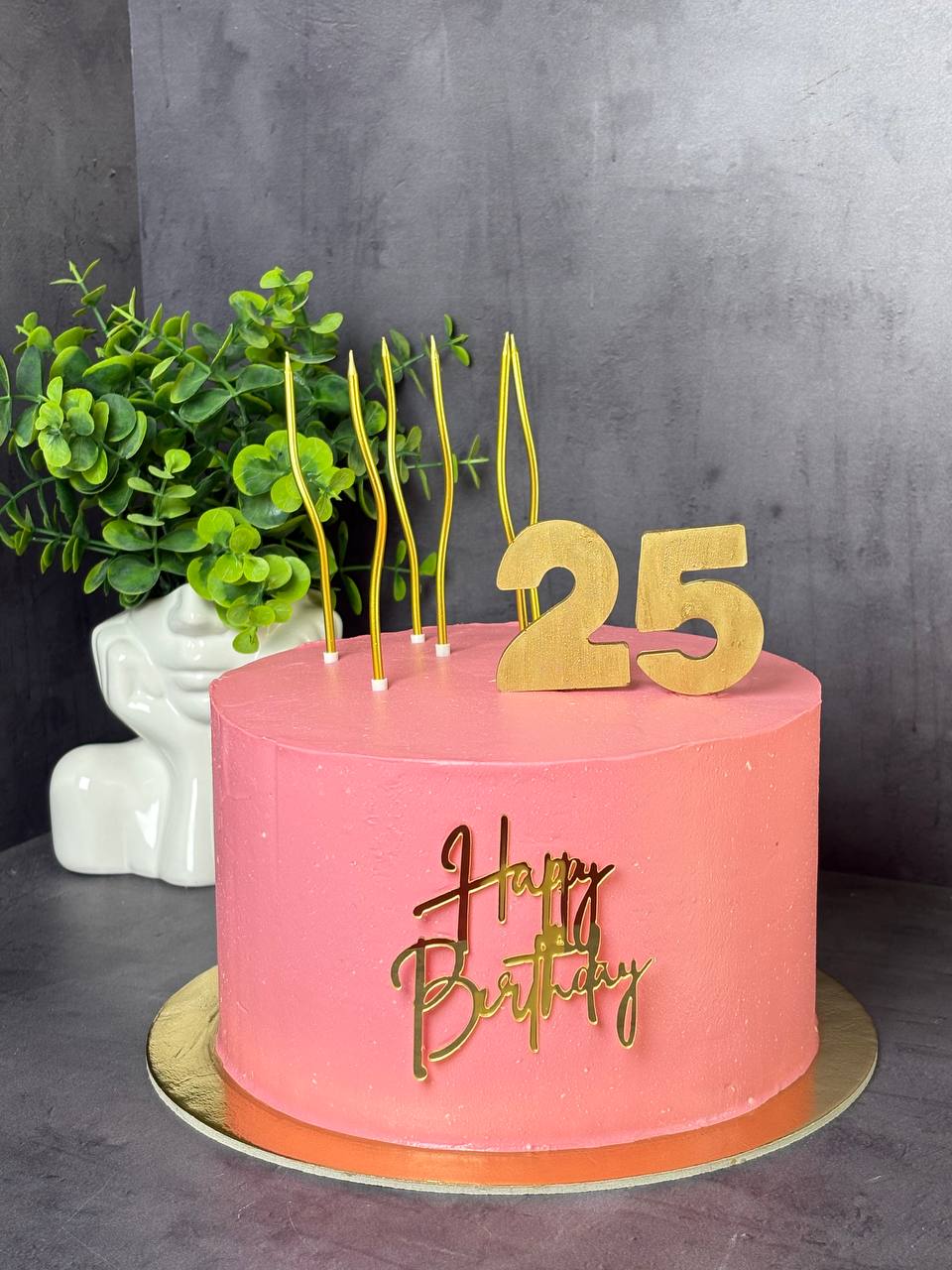 Pink 25th birthday cake with gold candles