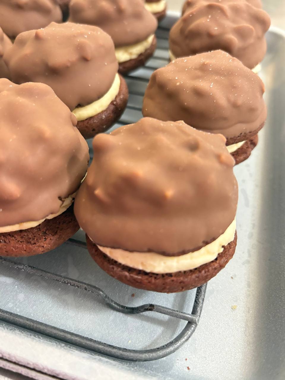 Chocolate-dipped whoopie pies with cream filling