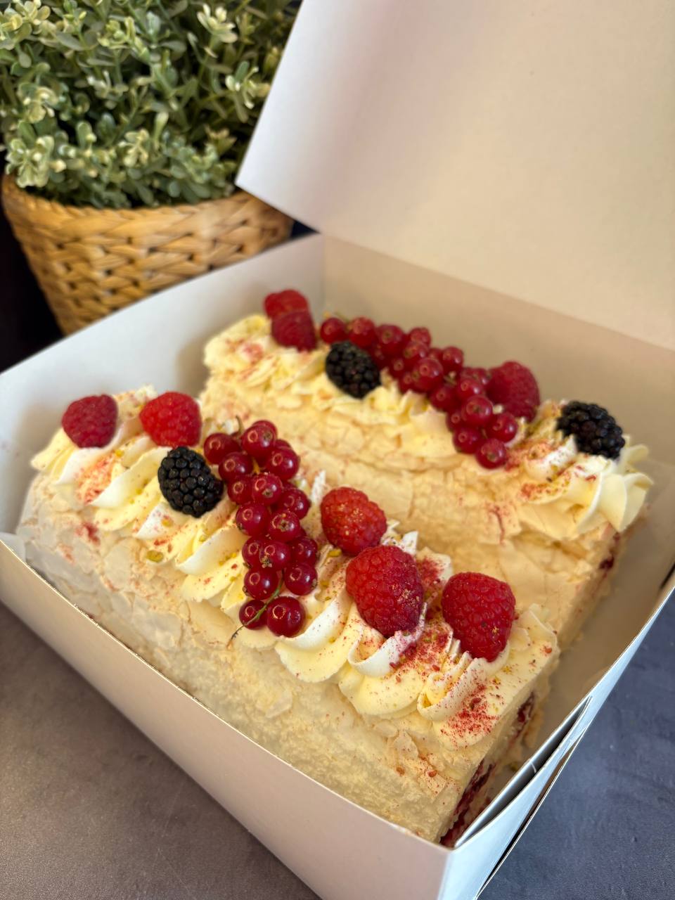 Large pavlova with cream and fresh berries