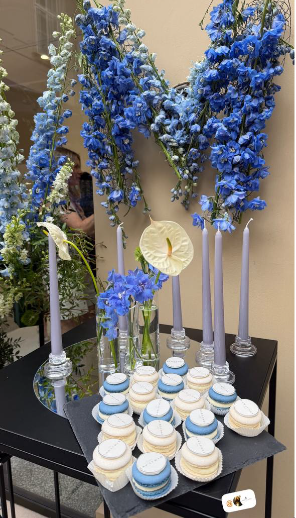 Branded macarons dessert table with blue delphinium letter M